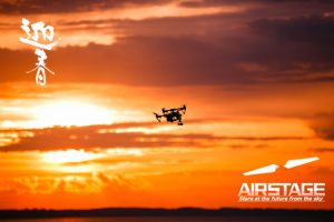 drone with remote control. Dark silhouette against colorfull sunset. Soft focus. Toned image
